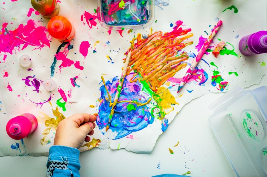 Colorful painting in progress with paint pots